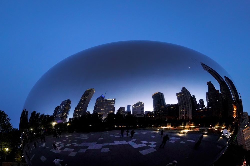The Chicago Archdiocese announced Dec. 17 that beginning in January its nearly 400 parishes, schools, cemeteries and offices will switch to 100% renewabThe Chicago skyline is reflected on Anish Kapoor's stainless steel sculpture Cloud Gate, also known as "The Bean," in the city's Millennium Park Thursday, May 25.